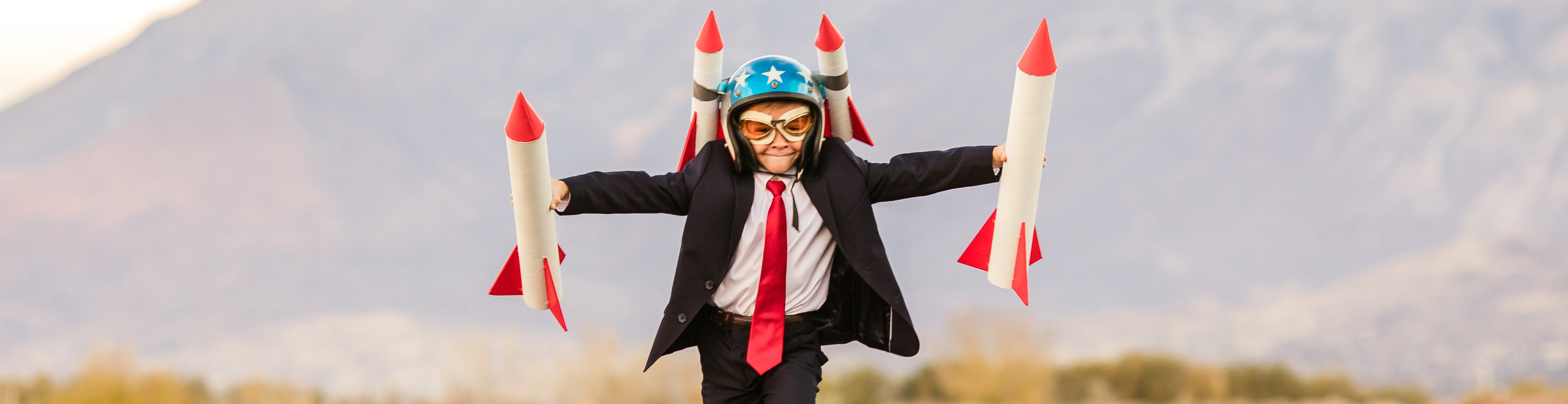 Boy running with toy rockets